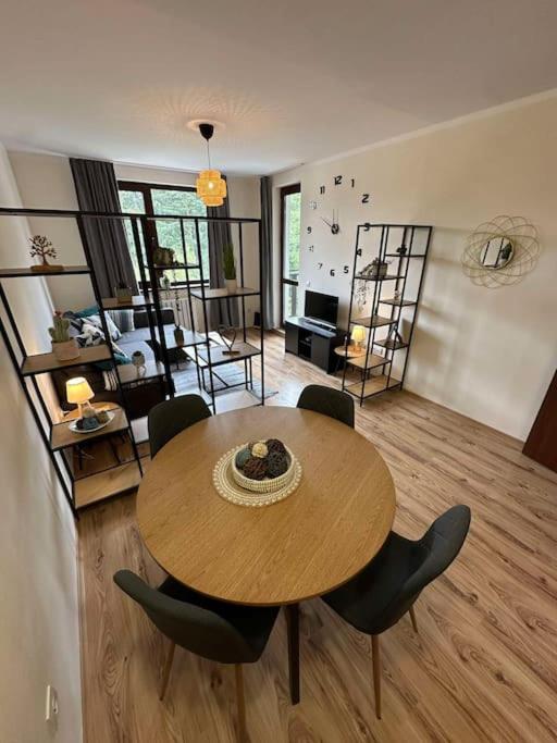 a living room with a wooden table and chairs at large apartment in Borovets in Borovets