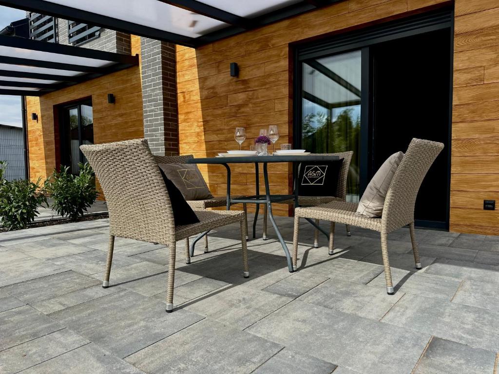 a dining table and chairs on a patio at Apartamenty A&M Premium in Stargard