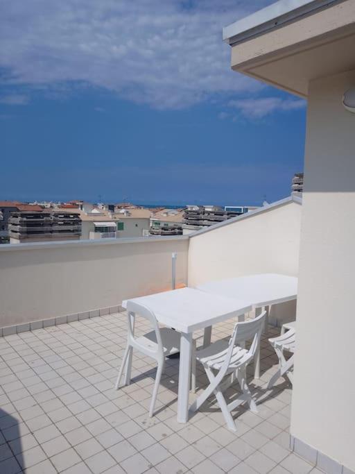 a white table and chairs on top of a roof at Octopus house in Civitanova Marche