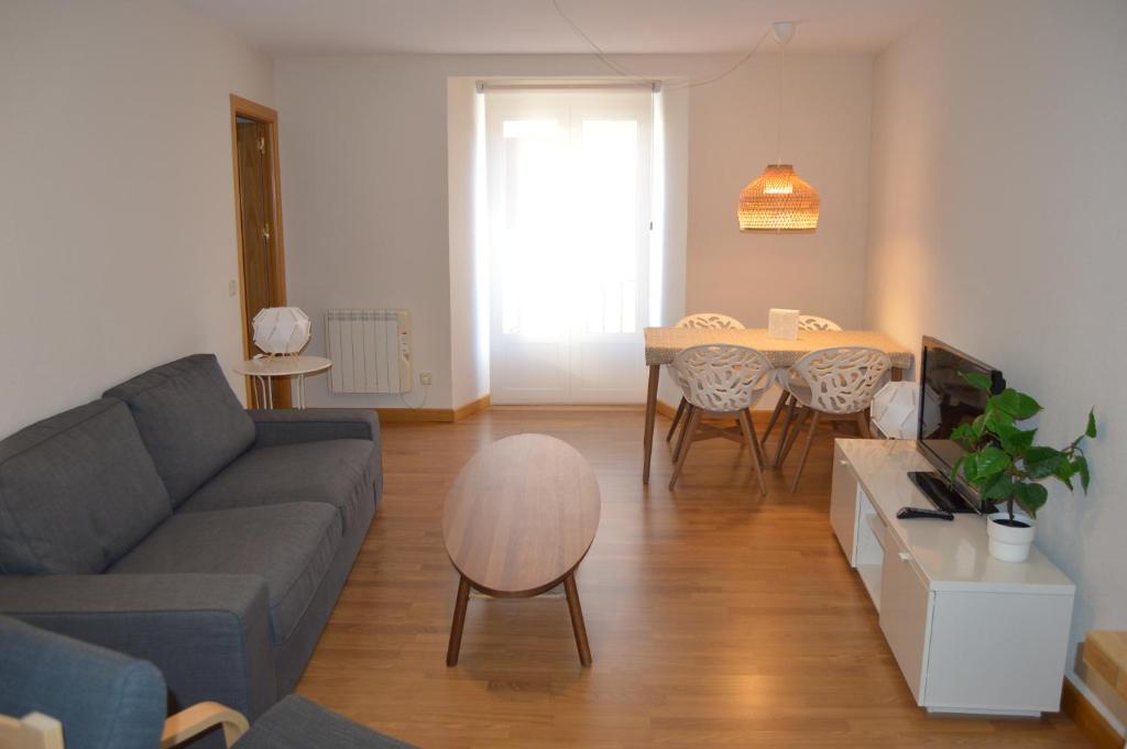 a living room with a couch and a table at Vut Casa de los Leales - Ávila in Ávila