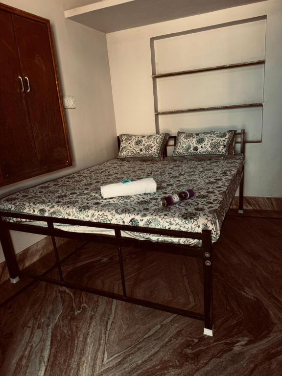 a bed in a room with two bottles on it at Rose Merry Guesthouse in Bikaner