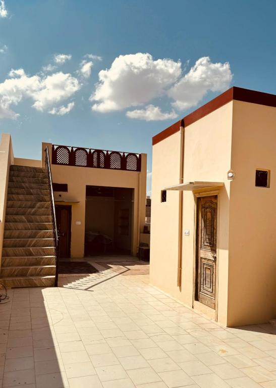 a building with a staircase next to a door at Rose Merry Guesthouse in Bikaner
