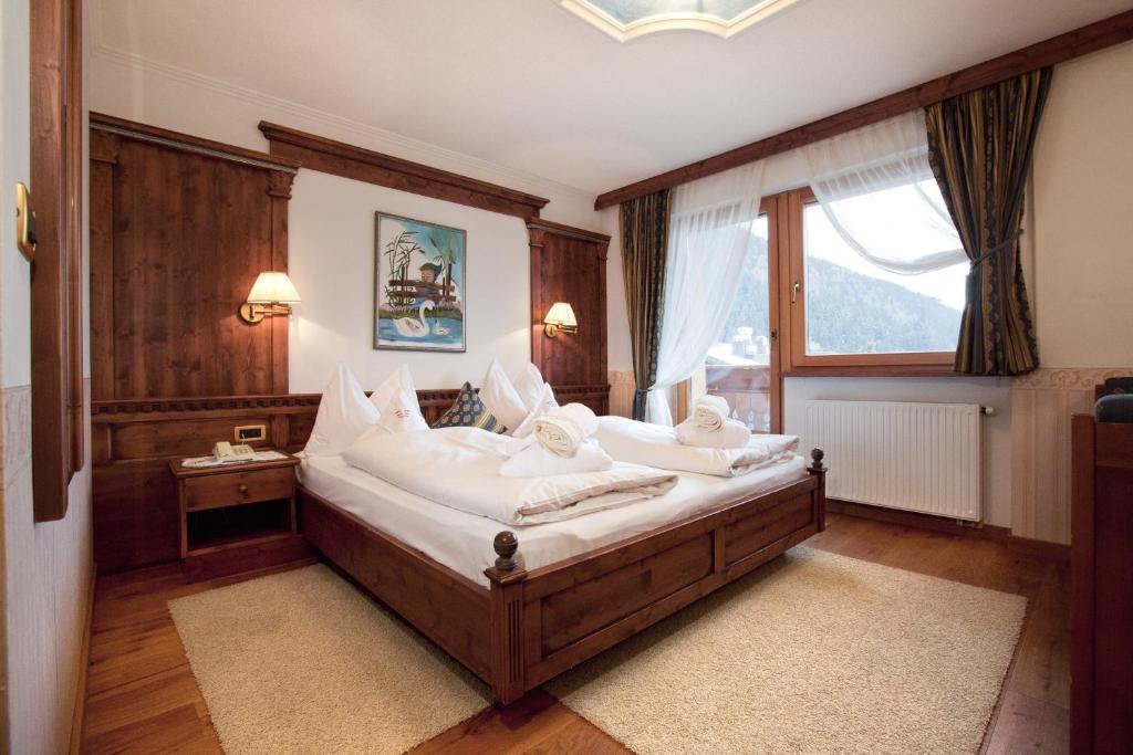 Hotel Garni Concordia - Dolomites Homeにあるベッド