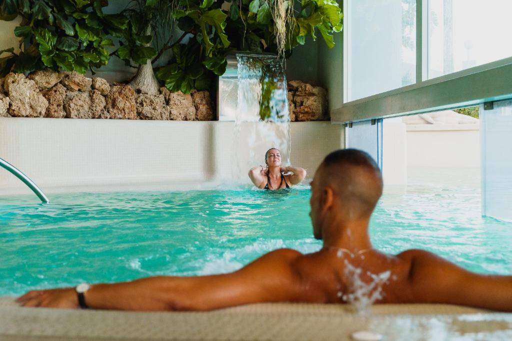 a man in a bath tub in a swimming pool at Romantica Room & SPA in Ischia