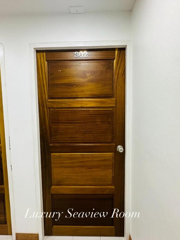 a wooden door in a room with at Surin Bay Inn in Surin Beach