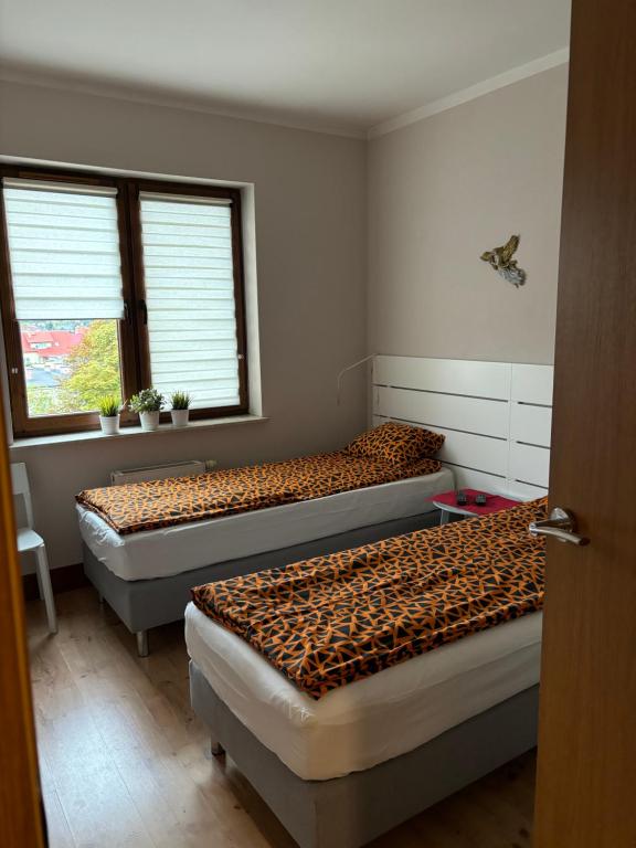 Posteľ alebo postele v izbe v ubytovaní Apartament Józefa