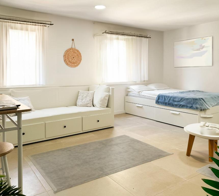 a bedroom with two beds and a couch at Costa by Hawkins Algeciras - Exterior 3B in Algeciras