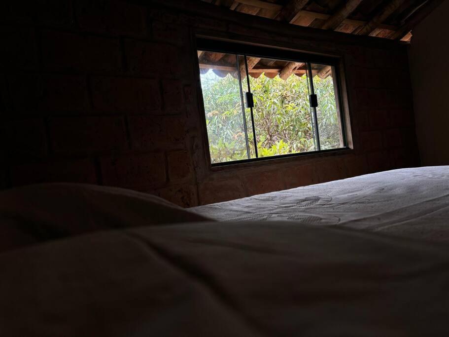 Letto o letti in una camera di Vila do Salitre - Chalé a 5 min de lagos e cachoeiras