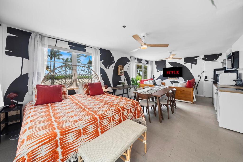 a bedroom with a bed with red pillows on it at Beachfront Ocean View Apartment on Ocean Drive in Miami Beach