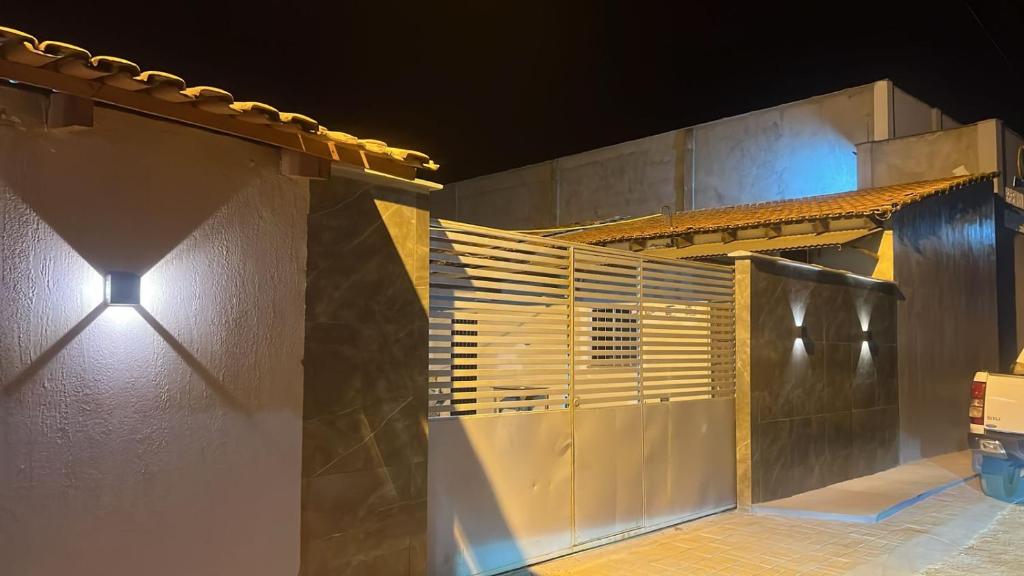 a building with a light on the side of it at Quarto Suíte independente da casa com garagem in Carolina