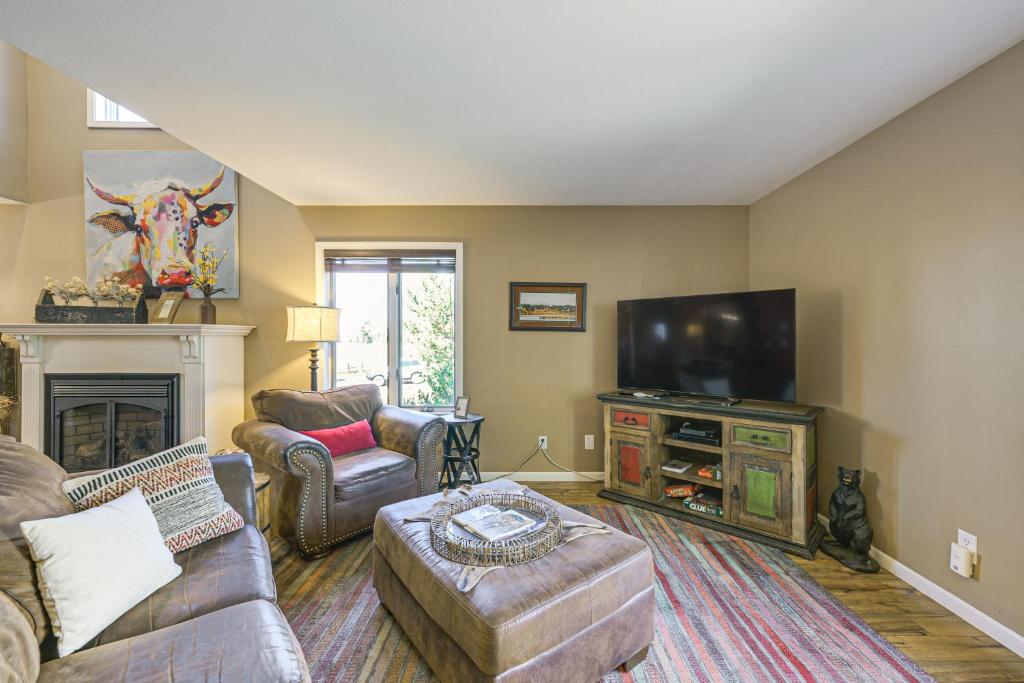 a living room with a couch and a flat screen tv at Hike, Ski and Dine Pagosa Springs Getaway! in Pagosa Springs