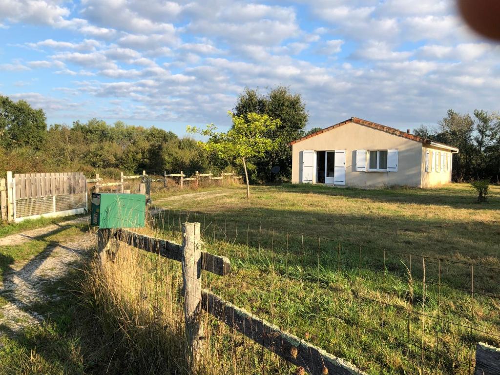 une clôture devant une maison dans un champ dans l'établissement Maison de campagne meublée, à Issac