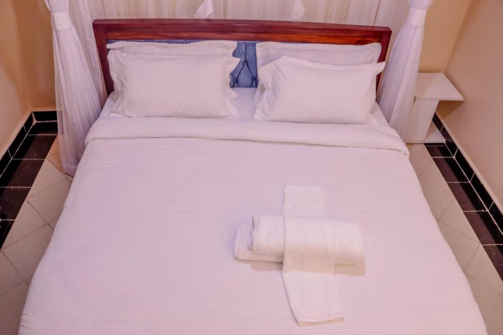 Postel nebo postele na pokoji v ubytování Dayo Suites and Hotel