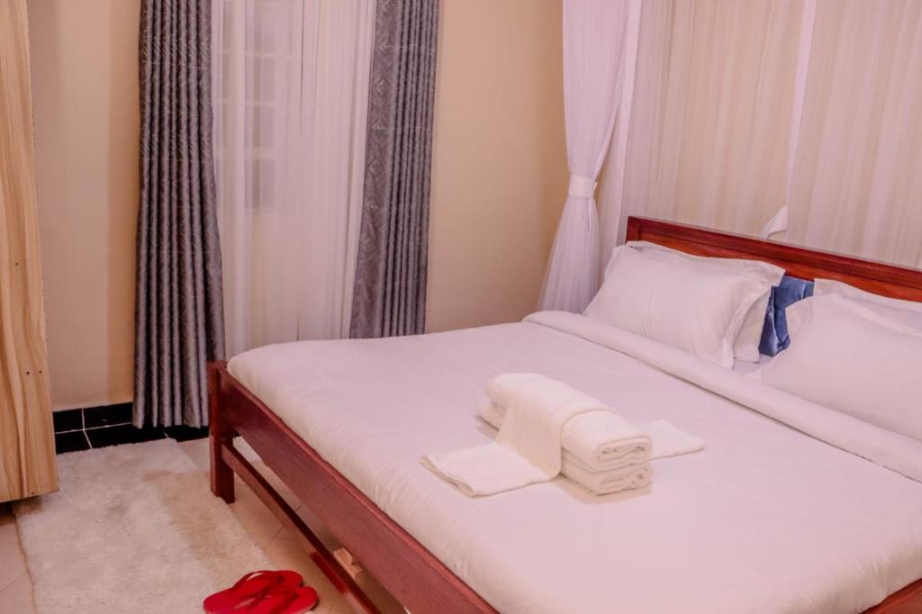 Postel nebo postele na pokoji v ubytování Dayo Suites and Hotel
