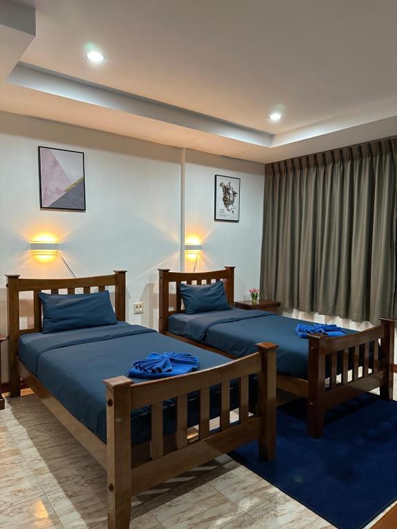 Postel nebo postele na pokoji v ubytování BT hotel Kata Beach