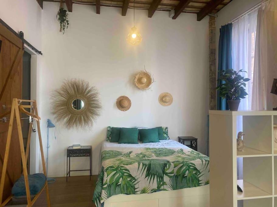 a bedroom with a bed with green pillows at ruzafa oceanograf science center in Valencia