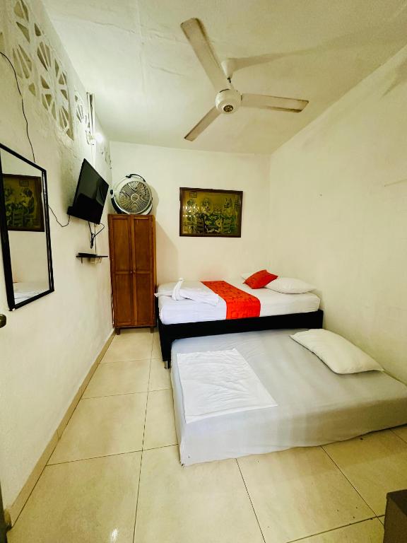 Postel nebo postele na pokoji v ubytování Hostal La Española de Getsemani