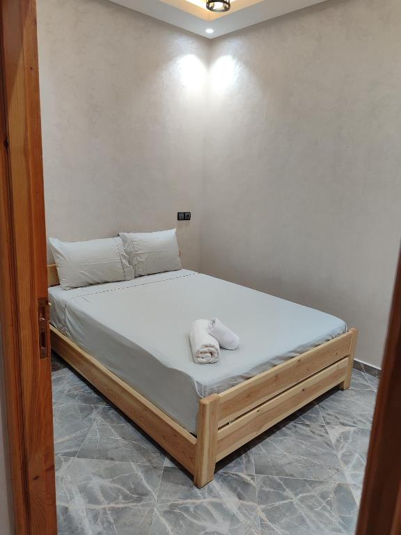 a bed with white sheets and pillows in a room at Sea Breeze 4 in Imsouane