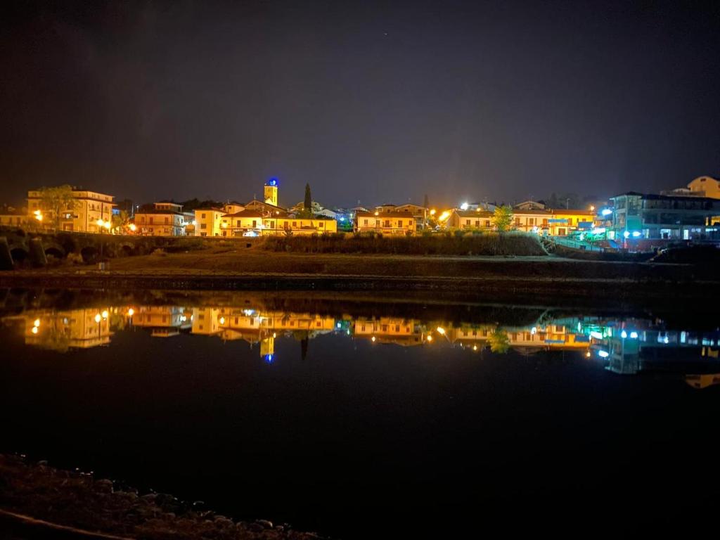 a city at night with a body of water at B&B da Maria & Renato il Lago Trattoria in Mirabella Eclano