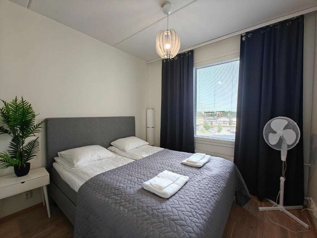 a bedroom with a bed with two towels on it at Lovely 2R apartment, parking in Oulu