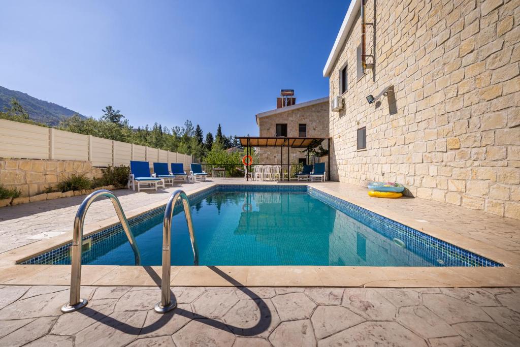 a swimming pool in front of a building at JP Pool House in Trimiklini