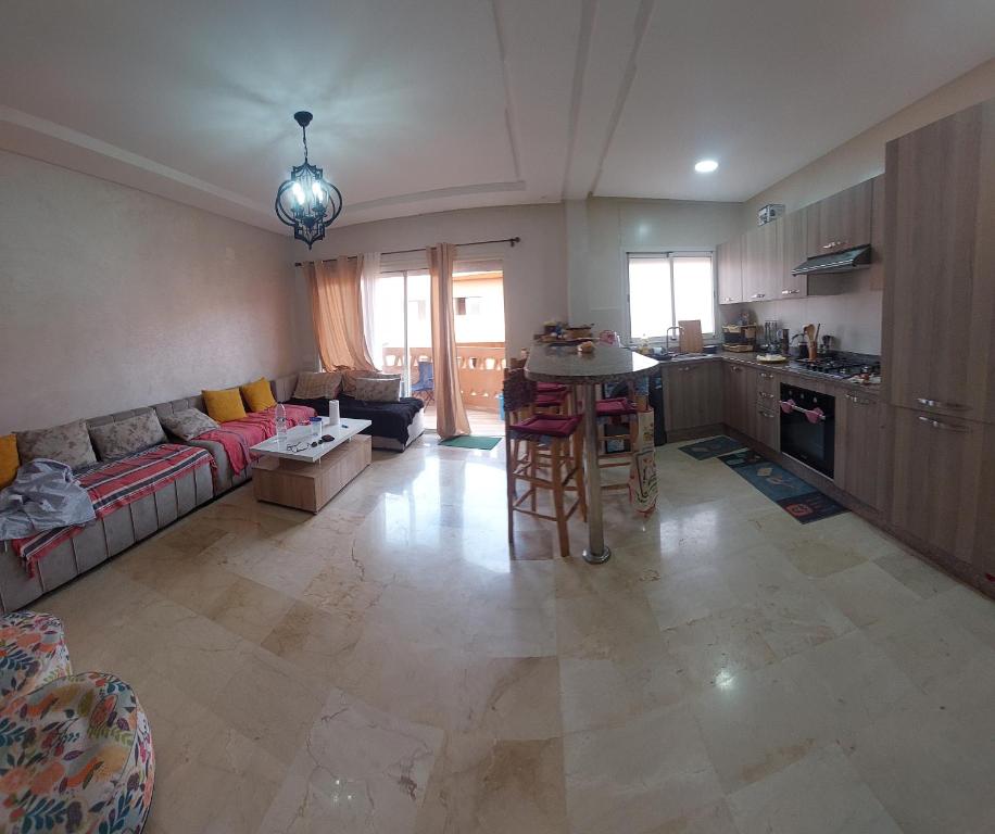 a large living room with a couch and a table at Goulmim in Mohammedia