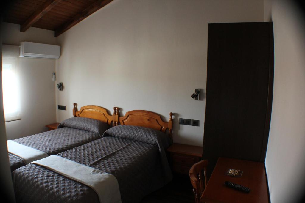 Posteľ alebo postele v izbe v ubytovaní Hostal Extremeño