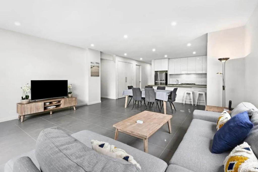 a living room with a couch and a table at Seaside Retreat, St Leonards in Saint Leonards
