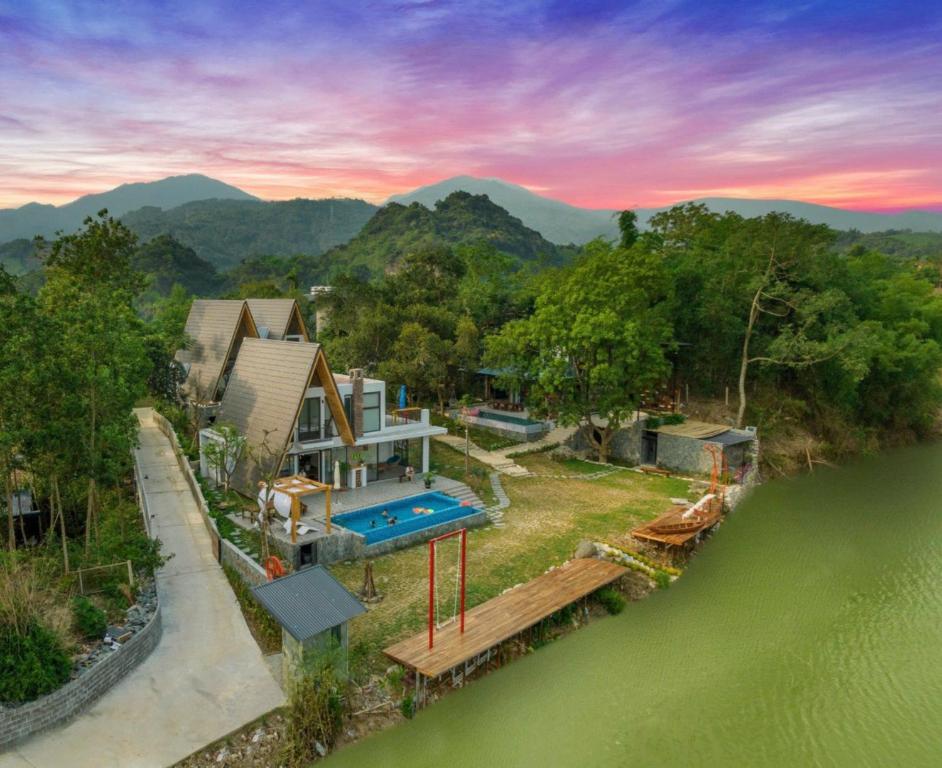 an aerial view of a house next to a river at LaLa Villas in Hòa Bình