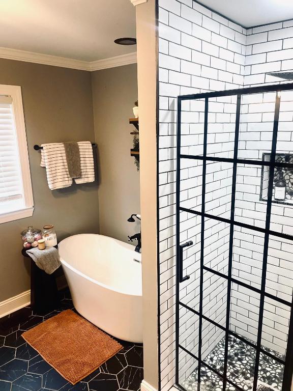 a bathroom with a bath tub and a window at Private Cottage on Lookout Mountain Near Ruby Falls & Rock City in Lookout Mountain