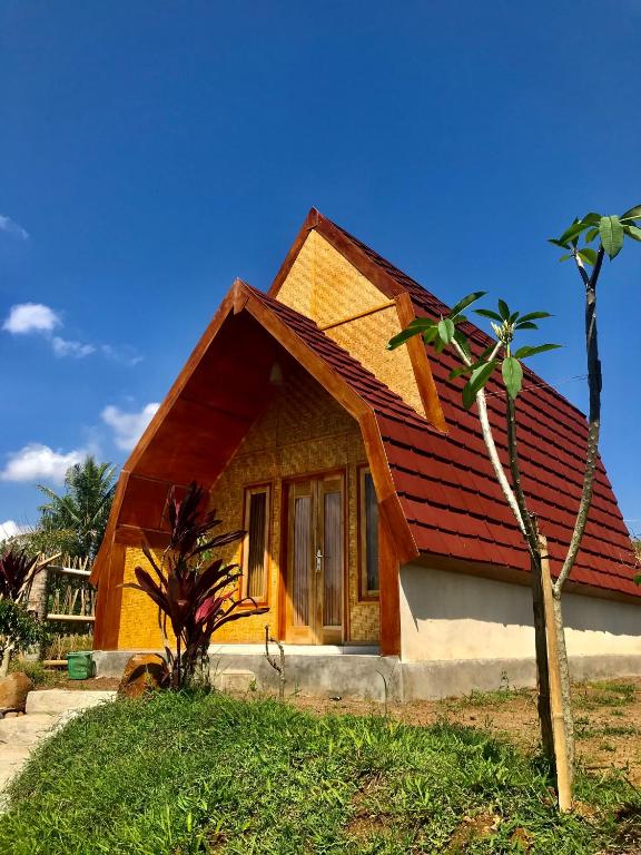 a small house with a red roof at Eger Rise Terrace Bungalow in Kotaraja