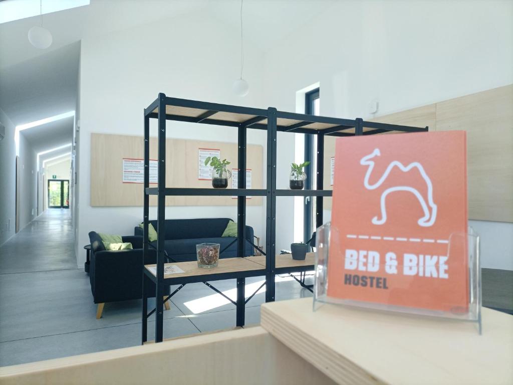 a sign in a room with a bed and bike museum at Bed & Bike Hostel in San Giovanni in Persiceto