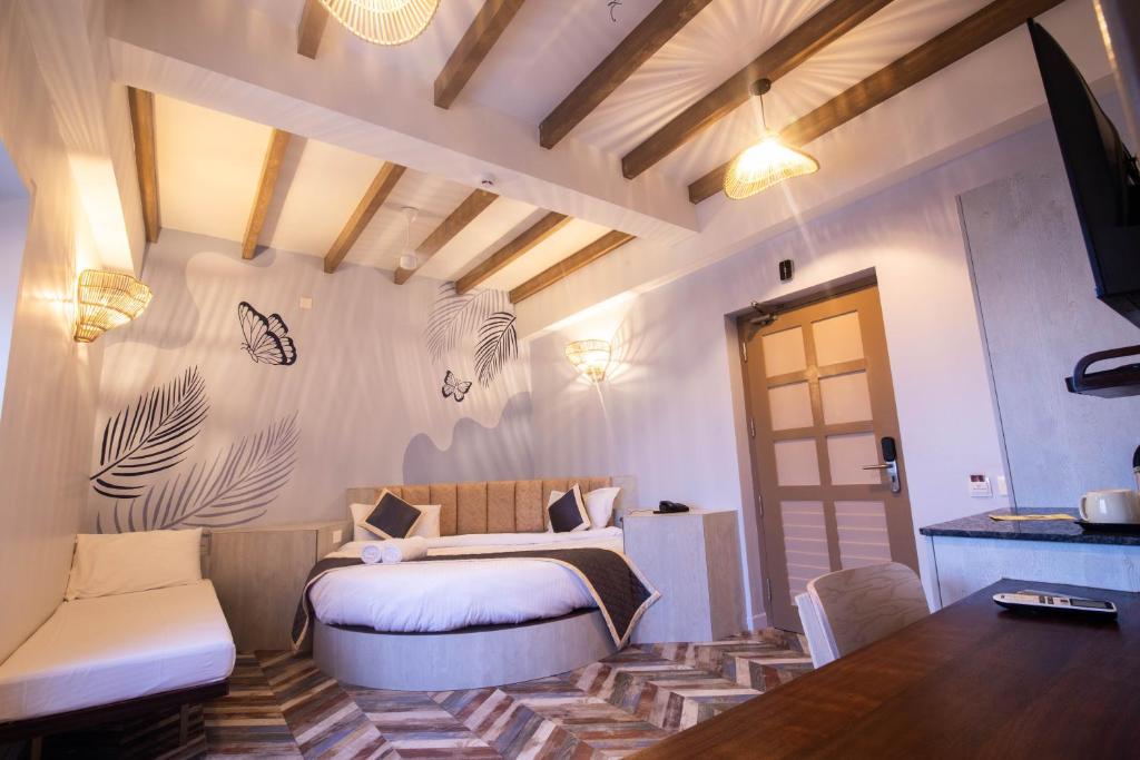Postel nebo postele na pokoji v ubytování La Papillon Maison