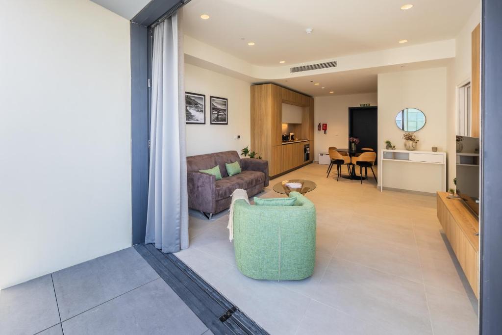 a living room with a couch and a table at The Signature Suite in Mercury Tower in St. Julianʼs