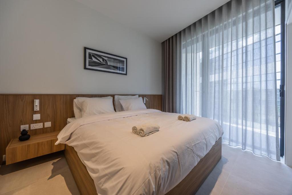 a bedroom with a large bed and a large window at The Signature Suite in Mercury Tower in St. Julianʼs