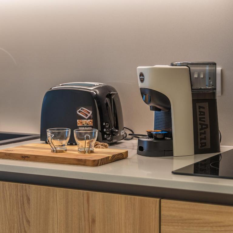 a toaster and two glasses on a counter at The Signature Suite in Mercury Tower in St. Julianʼs