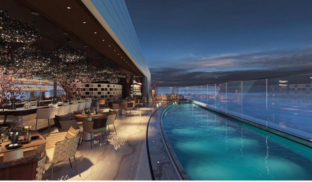 a hotel with a swimming pool in a building at The Signature Suite in Mercury Tower in St. Julianʼs