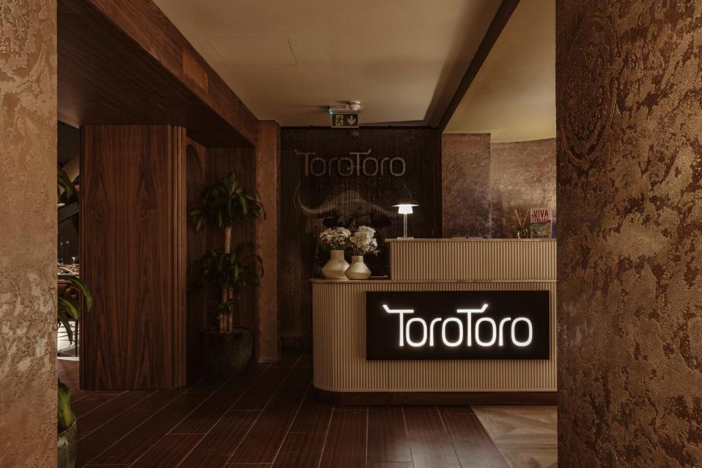 a tooto store with a sign in a lobby at The Signature Suite in Mercury Tower in St. Julianʼs
