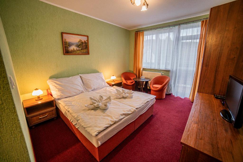 Postel nebo postele na pokoji v ubytování Penzión Alpský dom