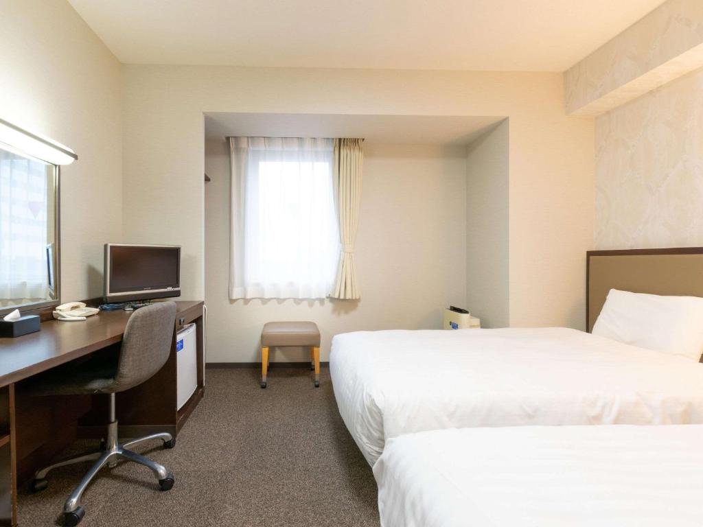 Postel nebo postele na pokoji v ubytování Comfort Hotel Toyama