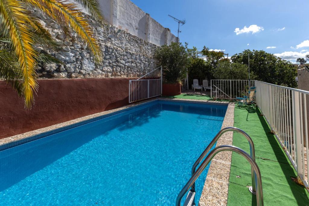 a swimming pool with blue water in front of a building at Villa Florita in Valdelaguna