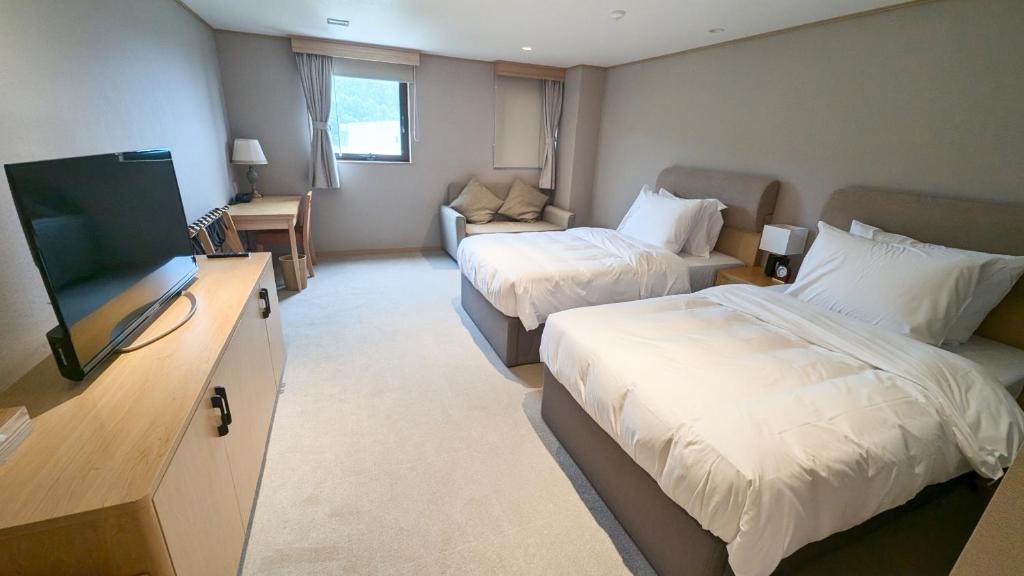 Postel nebo postele na pokoji v ubytování T Hotel Ryuoo
