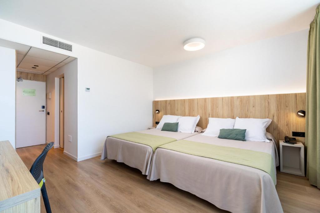 a bedroom with a large bed in a room at Ohtels Carabela in Matalascañas