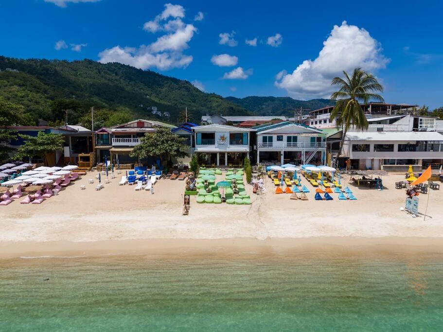 a beach with chairs and umbrellas on the beach at Aidan Beachfront Suites 5 Bed Lamai - KBR28 in Amphoe Koh Samui