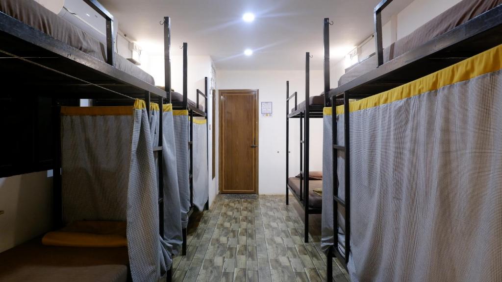 a room with a row of bunk beds at BunkNBrew in Palolem
