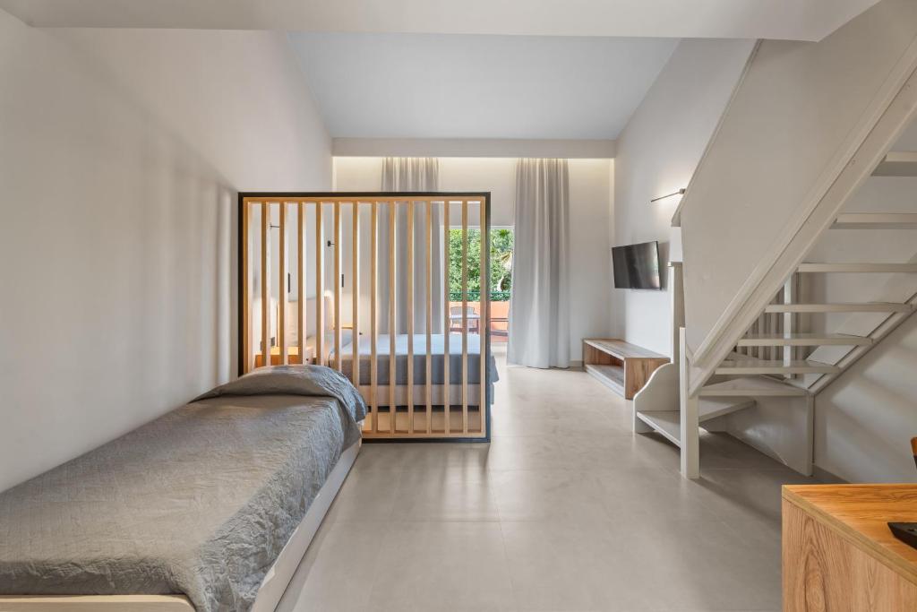 una camera con un letto e una scala di Aqualand Resort ad Ágios Ioánnis