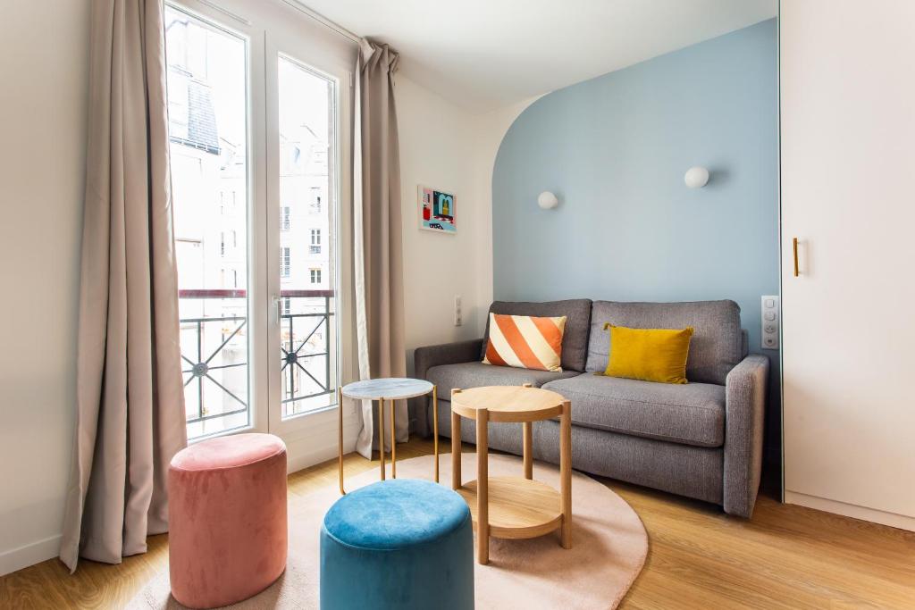 - un salon avec un canapé, des tables et une fenêtre dans l'établissement Stunning apartment - 2BR-6P - Paris Center, à Paris