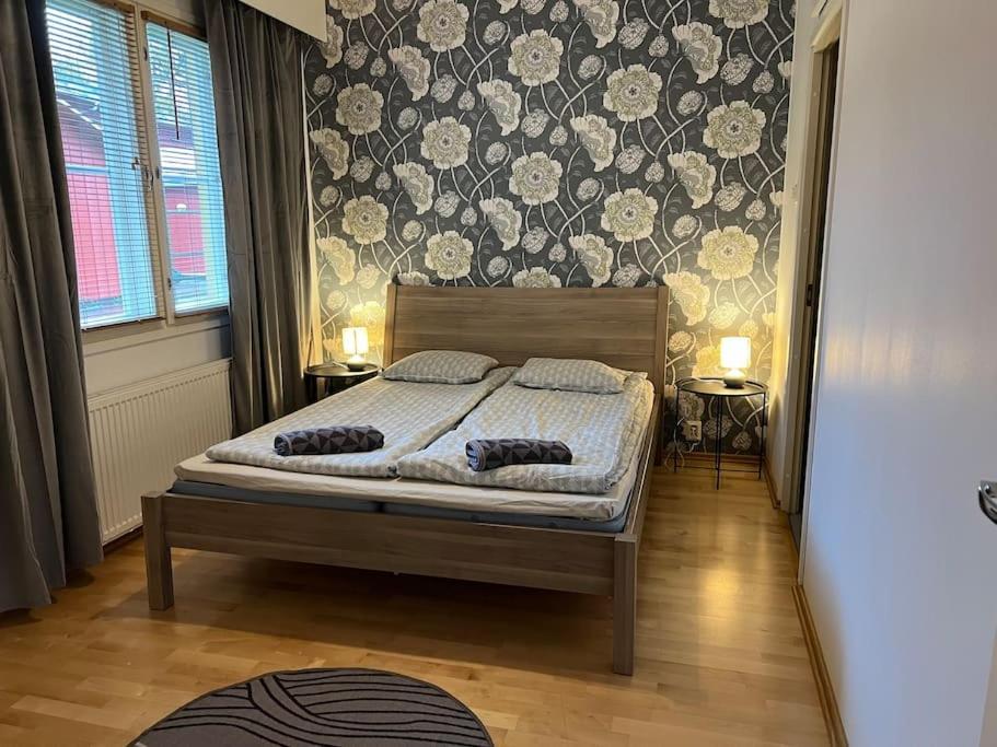 a bedroom with a bed with two pillows on it at Apartment Vaatturi in Kokkola