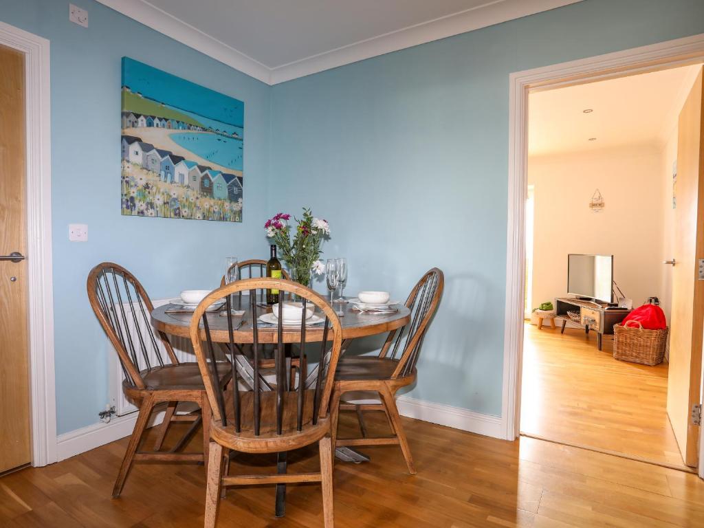a dining room with a table and chairs at Tides Reach in Rhosneigr