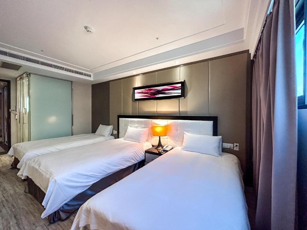 Postel nebo postele na pokoji v ubytování Royal Fine Hotel